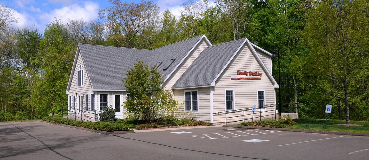 The Callis Family Dentistry office, a gray-shingled building with a Family Dentistry sign, on Old Toll Road in Madison